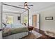 Light-filled main bedroom with a four-poster bed and views of the surrounding trees at 5854 Crimson Oak Ct, Harrisburg, NC 28075