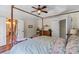 Spacious main bedroom with a four-poster bed and en-suite bathroom access at 5854 Crimson Oak Ct, Harrisburg, NC 28075