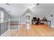 Open concept bonus room with hardwood floors, perfect for an office, playroom, or additional living space at 6730 Gold Wagon Ln, Mint Hill, NC 28227