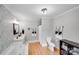 Bright bathroom features a soaking tub, wood floors, modern fixtures, and charming wallpaper at 6730 Gold Wagon Ln, Mint Hill, NC 28227
