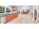 Open-concept kitchen featuring wood cabinets, granite countertops, and a view to the living area at 6730 Gold Wagon Ln, Mint Hill, NC 28227
