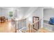 Bright staircase with wood and metal features, complemented by natural light and a mirror, adding sophistication at 6730 Gold Wagon Ln, Mint Hill, NC 28227