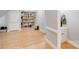 Bright bonus room with bookshelves and wood floors provides flexible living space at 6730 Gold Wagon Ln, Mint Hill, NC 28227