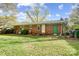 A well-maintained backyard features a grassy yard, brick exterior, and a fenced-in area at 7000 David Ave, Charlotte, NC 28214
