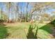 Large backyard surrounded by mature trees and an area to garden, perfect for outdoor activities at 7000 David Ave, Charlotte, NC 28214