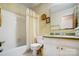 Well-lit bathroom featuring a vanity with mirror, toilet, and shower-tub combo at 7000 David Ave, Charlotte, NC 28214