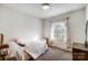 Bedroom with a bed, neutral colors and window dressed with decorative curtains at 7000 David Ave, Charlotte, NC 28214