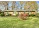 Charming single-story brick home with well-maintained lawn and mature trees at 7000 David Ave, Charlotte, NC 28214