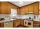Functional kitchen featuring wood cabinets and classic appliances at 7000 David Ave, Charlotte, NC 28214