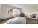 Bright living room featuring neutral walls, carpet, and large windows at 7000 David Ave, Charlotte, NC 28214