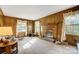 Cozy living room with paneled walls, fireplace, and natural light at 7000 David Ave, Charlotte, NC 28214