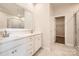 Modern bathroom with dual sinks, marble countertops, and a glass-enclosed shower, offering a spa-like experience at 7005 New Town Rd, Waxhaw, NC 28173
