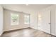 Cozy bedroom featuring wood flooring, natural light, and a door to the bathroom at 7005 New Town Rd, Waxhaw, NC 28173