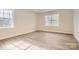 Bright, airy bedroom with large windows and ample natural light with wood flooring at 7005 New Town Rd, Waxhaw, NC 28173
