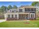 Beautiful two-story home with brick and siding, a manicured lawn, and classic architectural details at 7005 New Town Rd, Waxhaw, NC 28173
