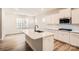 Bright kitchen with a large island, stainless steel appliances, and a view to the backyard at 7005 New Town Rd, Waxhaw, NC 28173