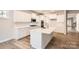Stylish kitchen features white cabinetry, stainless steel appliances, and a center island with a sink at 7005 New Town Rd, Waxhaw, NC 28173