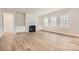Spacious living room with a fireplace, built-in cabinets, and large windows for natural light at 7005 New Town Rd, Waxhaw, NC 28173