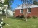 Brick house backyard featuring a storage shed, landscaped garden and well-maintained lawn at 701 Dakota St, Kannapolis, NC 28083