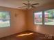 Bright bedroom with wood floors and trim, neutral walls, and views from large windows at 701 Dakota St, Kannapolis, NC 28083