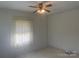 This cozy bedroom features tile floors, neutral paint, and a lighted ceiling fan at 701 Dakota St, Kannapolis, NC 28083