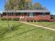 Charming brick home with a well-manicured lawn and colorful shrubbery at 701 Dakota St, Kannapolis, NC 28083