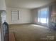 Spacious living room with a classic fireplace and neutral carpeting at 701 Dakota St, Kannapolis, NC 28083