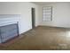 Spacious living room with a classic fireplace and neutral carpeting at 701 Dakota St, Kannapolis, NC 28083