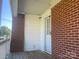 View of the white door on the brick patio at 701 Dakota St, Kannapolis, NC 28083
