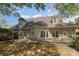 An exterior shot of the back of the home, showing the patio area and surrounding trees at 7900 Gilead Rd, Huntersville, NC 28078