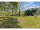 Expansive backyard with mature trees and a small shed in a tranquil setting at 7900 Gilead Rd, Huntersville, NC 28078