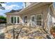 An exterior view showcasing a home's backyard patio with a mix of stone and siding at 7900 Gilead Rd, Huntersville, NC 28078