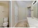 Bathroom with a vanity sink, a toilet, and a door to a storage area at 7900 Gilead Rd, Huntersville, NC 28078