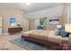 Cozy staged bedroom featuring a bed, a dresser, a ceiling fan, and natural light at 7900 Gilead Rd, Huntersville, NC 28078