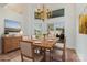 Dining room boasts natural light, a modern chandelier, and neutral decor at 7900 Gilead Rd, Huntersville, NC 28078