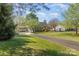 Beautiful home featuring a sprawling front yard, mature trees, and a long driveway at 7900 Gilead Rd, Huntersville, NC 28078