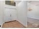 Home foyer featuring a double front door, chandelier and neutral color palette at 7900 Gilead Rd, Huntersville, NC 28078