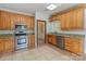Well-lit kitchen featuring stainless steel appliances, custom cabinets, and granite countertops at 7900 Gilead Rd, Huntersville, NC 28078