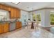 Eat-in kitchen featuring light cabinets, granite countertops, and stainless steel appliances at 7900 Gilead Rd, Huntersville, NC 28078