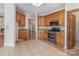 An open kitchen features stainless steel appliances, custom cabinets, granite countertops, and tile flooring at 7900 Gilead Rd, Huntersville, NC 28078