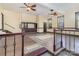 Open living room with built-in shelving, two ceiling fans and hardwood flooring with decorative rug at 7900 Gilead Rd, Huntersville, NC 28078