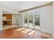 Bright living room featuring hardwood floors and French doors leading to the outside at 7900 Gilead Rd, Huntersville, NC 28078