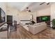 Open living room with hardwood floors, modern furnishings, and a flat screen tv at 7900 Gilead Rd, Huntersville, NC 28078