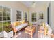 Bright sunroom featuring neutral decor, wood furniture, and large windows offering outdoor views at 7900 Gilead Rd, Huntersville, NC 28078