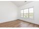 Bright bedroom features fresh paint, modern flooring, and a large window at 9287 Meadow Vista Rd, Charlotte, NC 28213