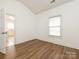 Bright bedroom with wood-look floors and lots of natural light from a window at 9287 Meadow Vista Rd, Charlotte, NC 28213