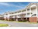 View of the condo complex with multiple stories, balconies, and manicured landscaping at 9287 Meadow Vista Rd, Charlotte, NC 28213