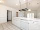 Well-lit kitchen island featuring dishwasher and plenty of cabinet space adjacent to living area at 9287 Meadow Vista Rd, Charlotte, NC 28213