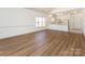 Open concept living space featuring modern wood flooring and a breakfast bar overlooking the kitchen at 9287 Meadow Vista Rd, Charlotte, NC 28213