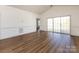 Bright living room featuring wood floors, neutral walls, and sliding doors to an outdoor balcony at 9287 Meadow Vista Rd, Charlotte, NC 28213